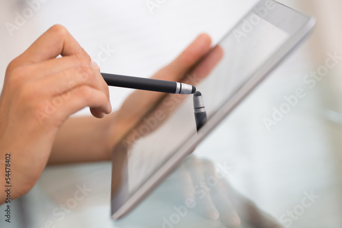 Fotografija Close-up of woman working with stylus and digital tablet pc