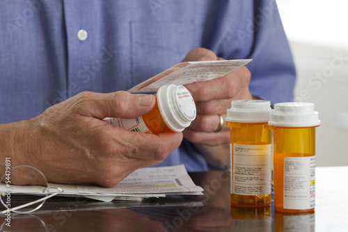 Older man with prescription medications, horizontal