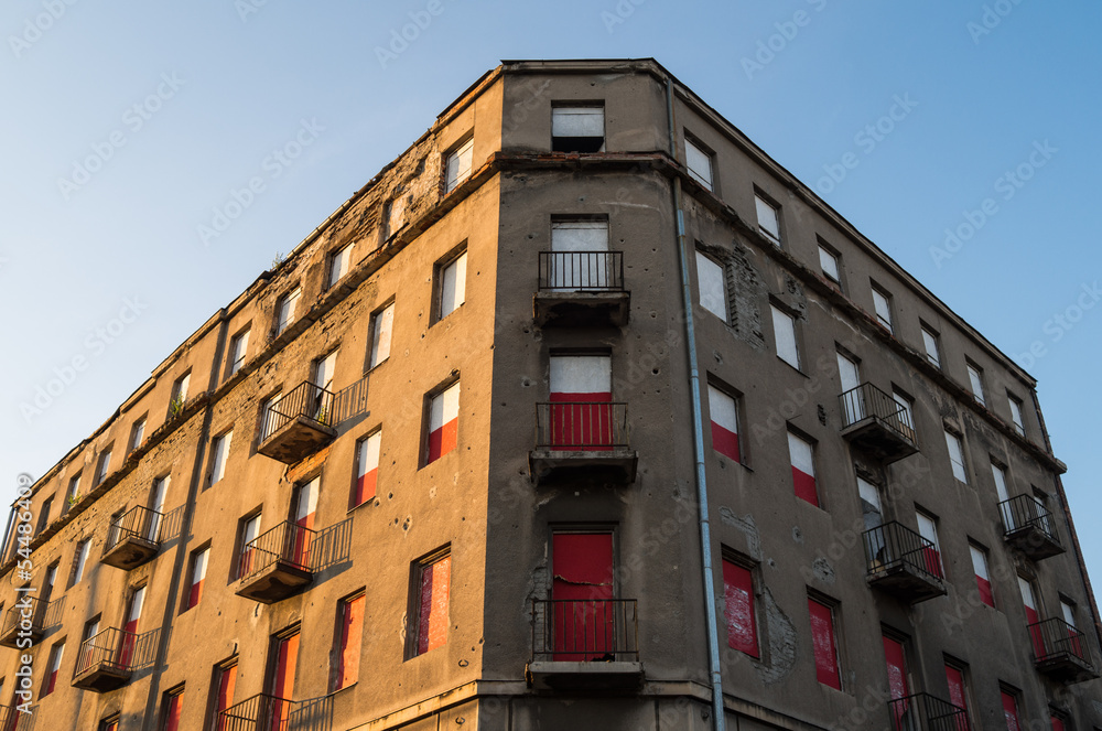 Fototapeta premium Old abandoned building with white and red windows