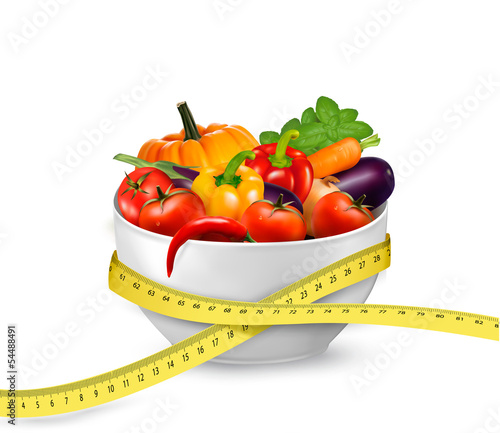 Diet meal. Vegetables in a bowl with measuring tape. Concept of