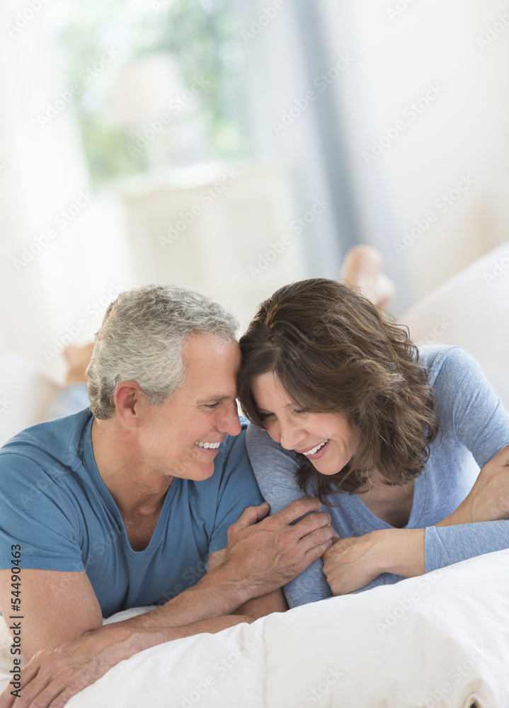 Fototapeta premium Romantic Couple Smiling In Bed