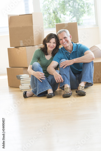Mature Couple Sitting Together On Floor In New House