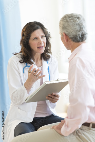 Doctor Discussing With Patient In Clinic