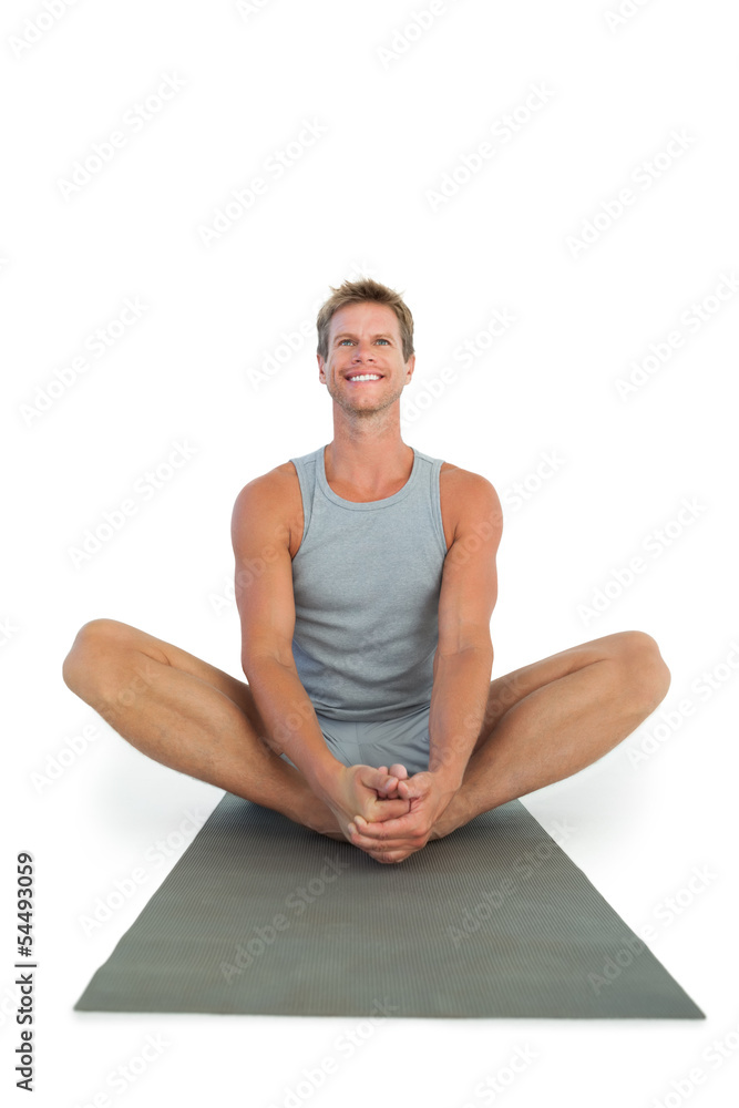 Man sitting in lotus position during a yoga session