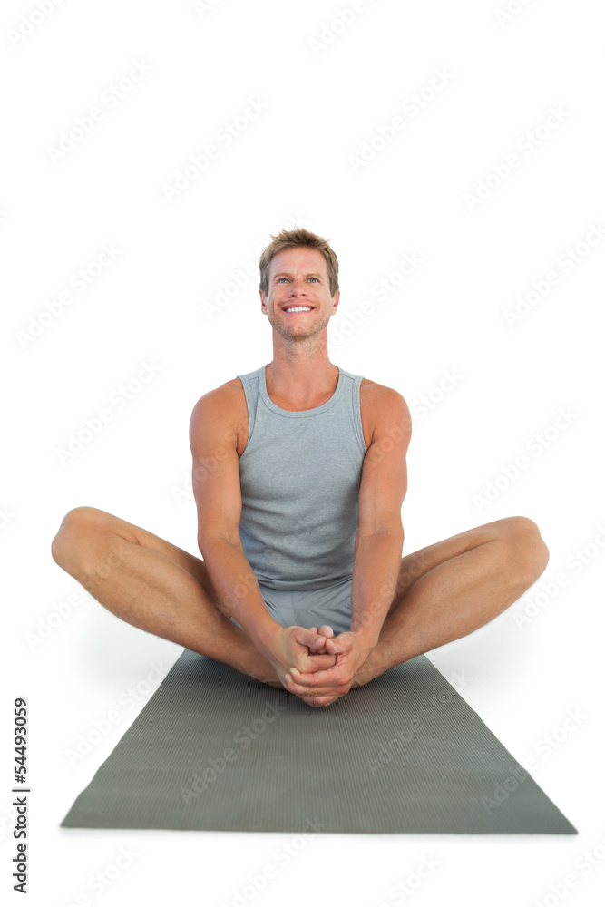 Man sitting in lotus position during a yoga session Man sitting in lotus position during a yoga session