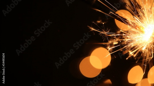 Sparkler and Christmas lights  with copy space.