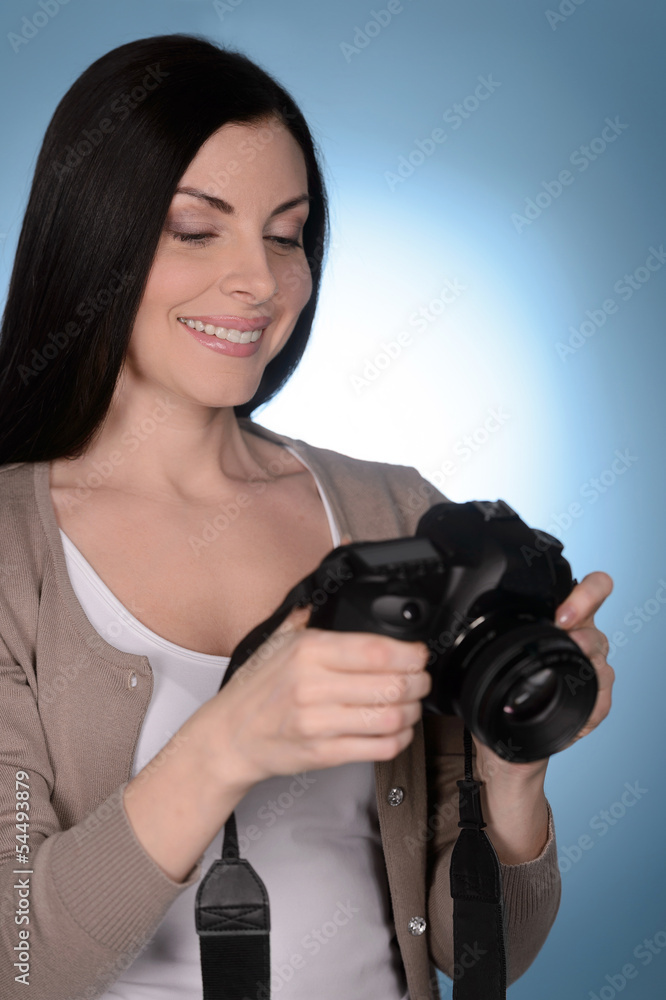 Her new hobby. Beautiful middle-aged women holding camera while Her new hobby. Beautiful middle-aged women holding camera while
