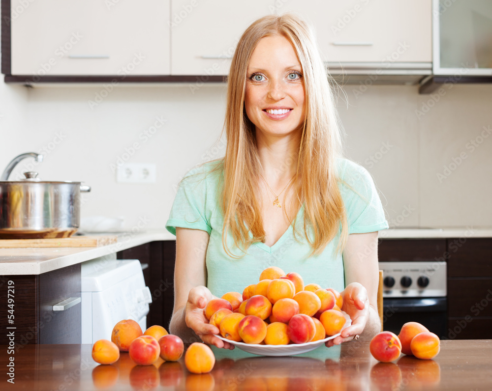  blonde housewife with fresh apricots