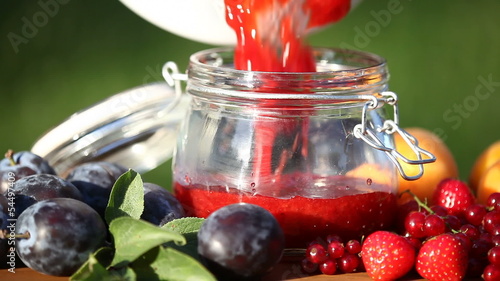 Jar with fresh homemade jam and fruits