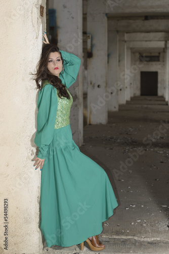 Attractive young lady posing somewhere in industrial ruins