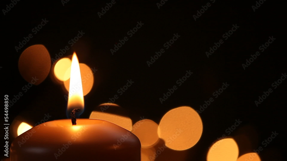 Igniting of candle on black background with copy space Igniting of candle on black background with copy space