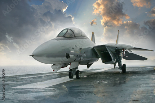 Canvas Print F-14 jet fighter on an aircraft carrier deck beneath dramatic cl
