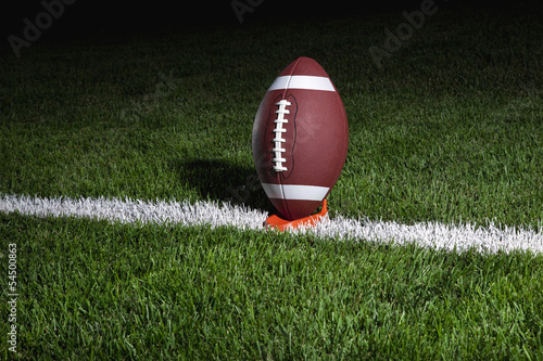 Photography College football on a tee at night
