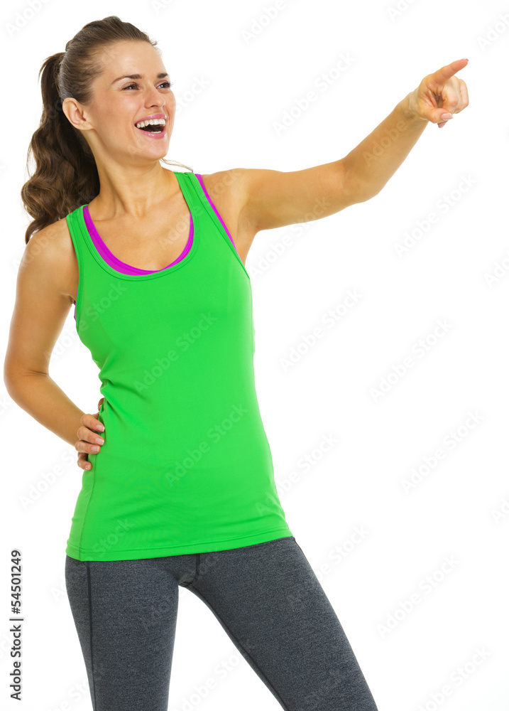 Smiling healthy young woman pointing on copy space Smiling healthy young woman pointing on copy space