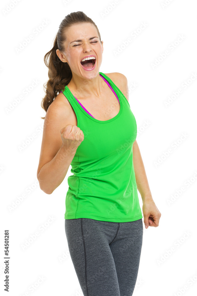 Happy fitness young woman making fist pump gesture Happy fitness young woman making fist pump gesture