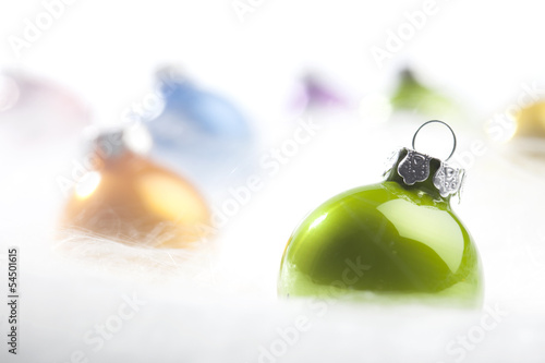 Green Christmas bauble in decorative snow