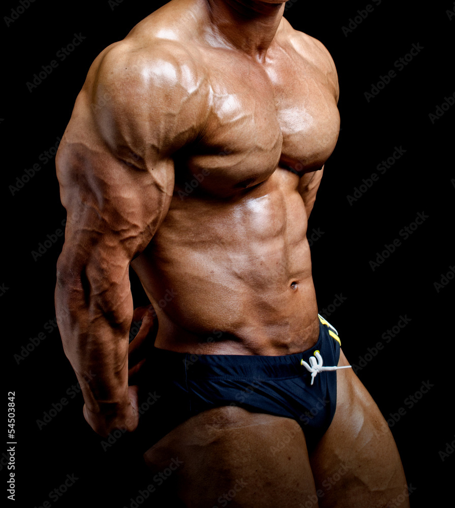 Premium Photo | Muscular man's side chest pose. bodybuilder posing on blue  background. close-up of ripped muscles. dieting is the key.