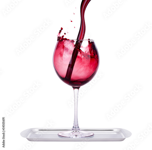 glass with red wine splash on a tray
