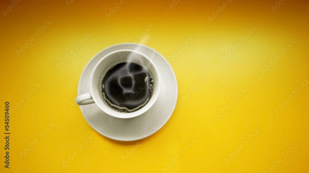 close up of coffee cup on yellow background close up of coffee cup on yellow background