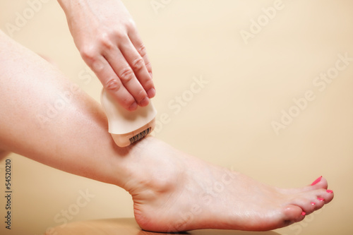 woman shaving leg with shaver depilation body care