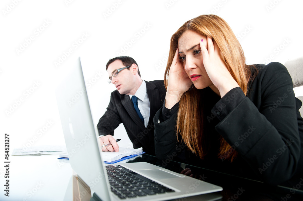 Two colleagues looking stressed whilst at work Two colleagues looking stressed whilst at work