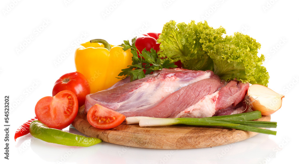 Raw meat and vegetables on a wooden board isolated on whitе Raw meat and vegetables on a wooden board isolated on whitе