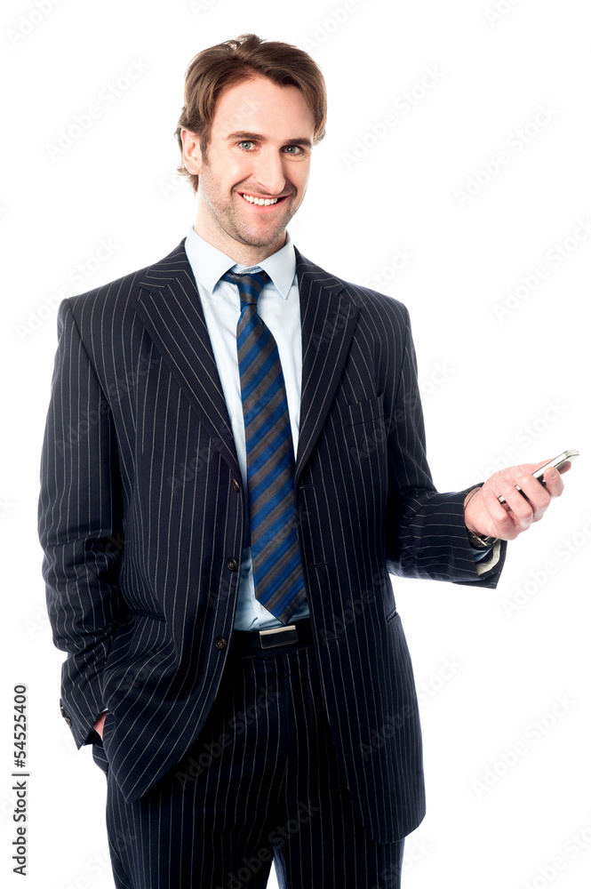 Smiling corporate head holding out cellphone Smiling corporate head holding out cellphone