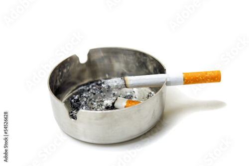 Cigarette and ashtray partially isolated on white