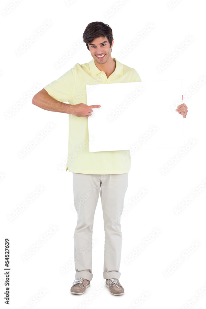 Smiling man pointing something on empty sign Smiling man pointing something on empty sign