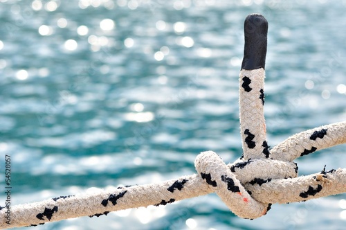 Knot on marine rope with blurred sea on background