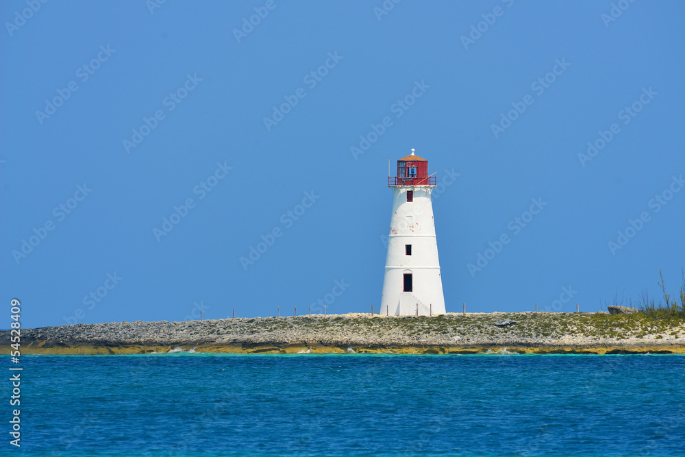 Lighthouse seen from a tiny beach in Nassau - Bahamas.