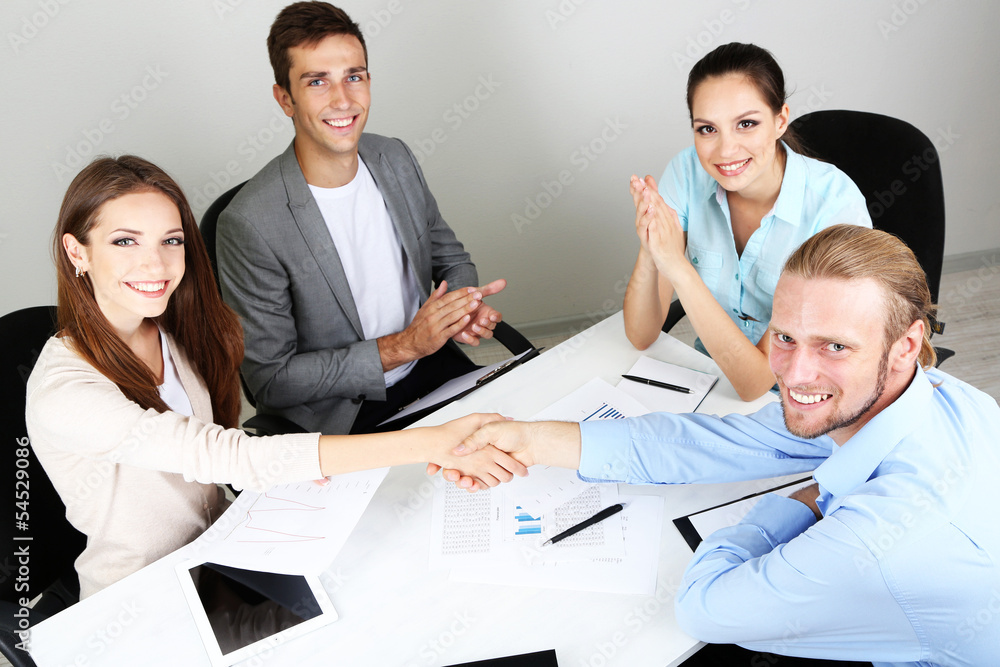 Business team working on their project together at office Business team working on their project together at office