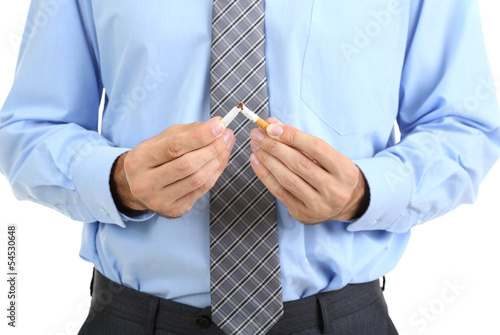 Business man breaks down the cigarette, isolated on white