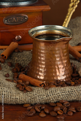 Metal turk and coffee beans on dark background