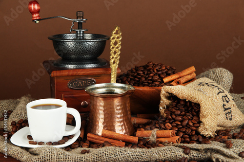 Metal turk and coffee cup on brown background