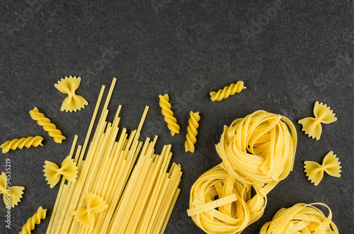 Verschiede Pastasorten auf einem Schieferhintergrund photo