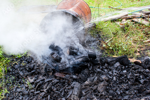Dousing charcoal to reduce temperature before packing
