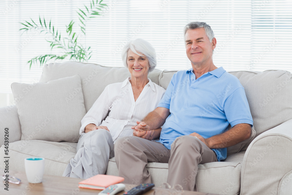 Mature couple sitting on a couch