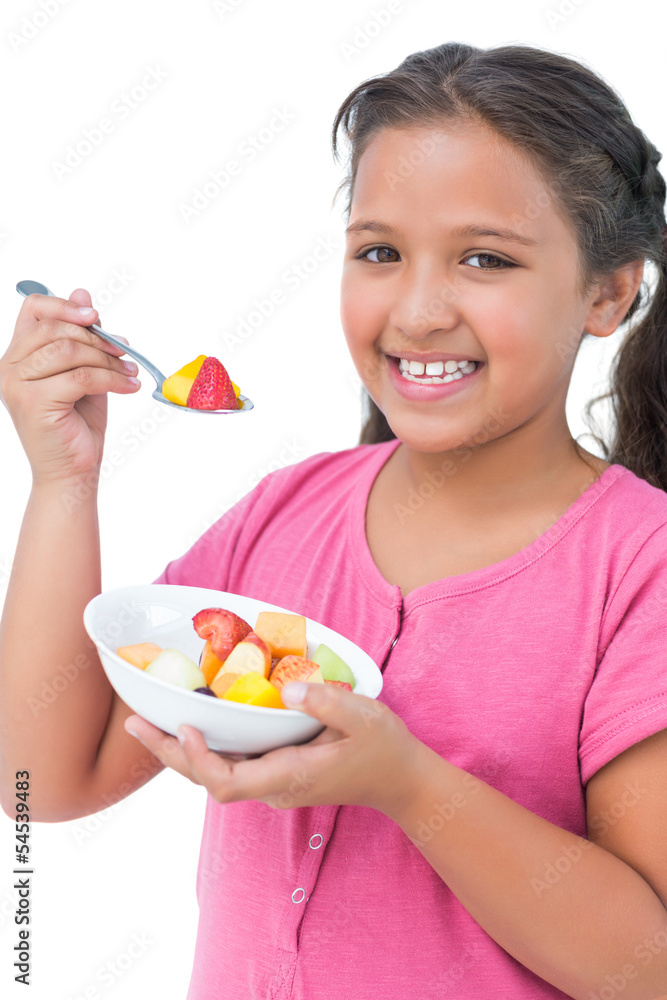 Happy little girl eating fruit salad Happy little girl eating fruit salad