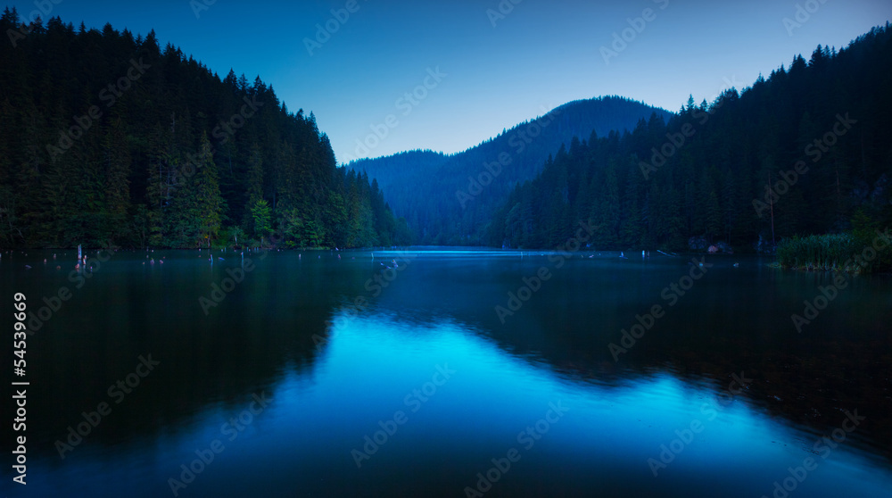 Blue serenity on a lake very early in the morning