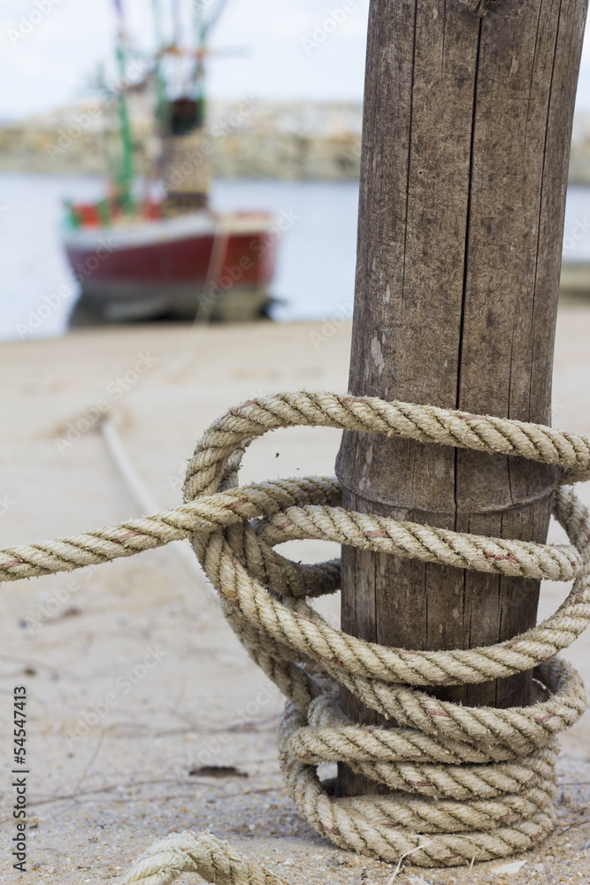 Fototapeta premium The rope tying boat with a wooden post
