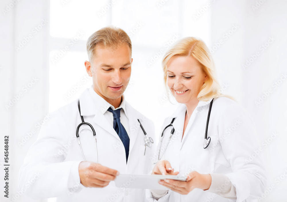 two doctors looking at tablet pc two doctors looking at tablet pc