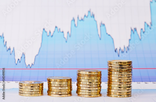 Uptrend stacks of golden coins and  financial  chart as backgrou