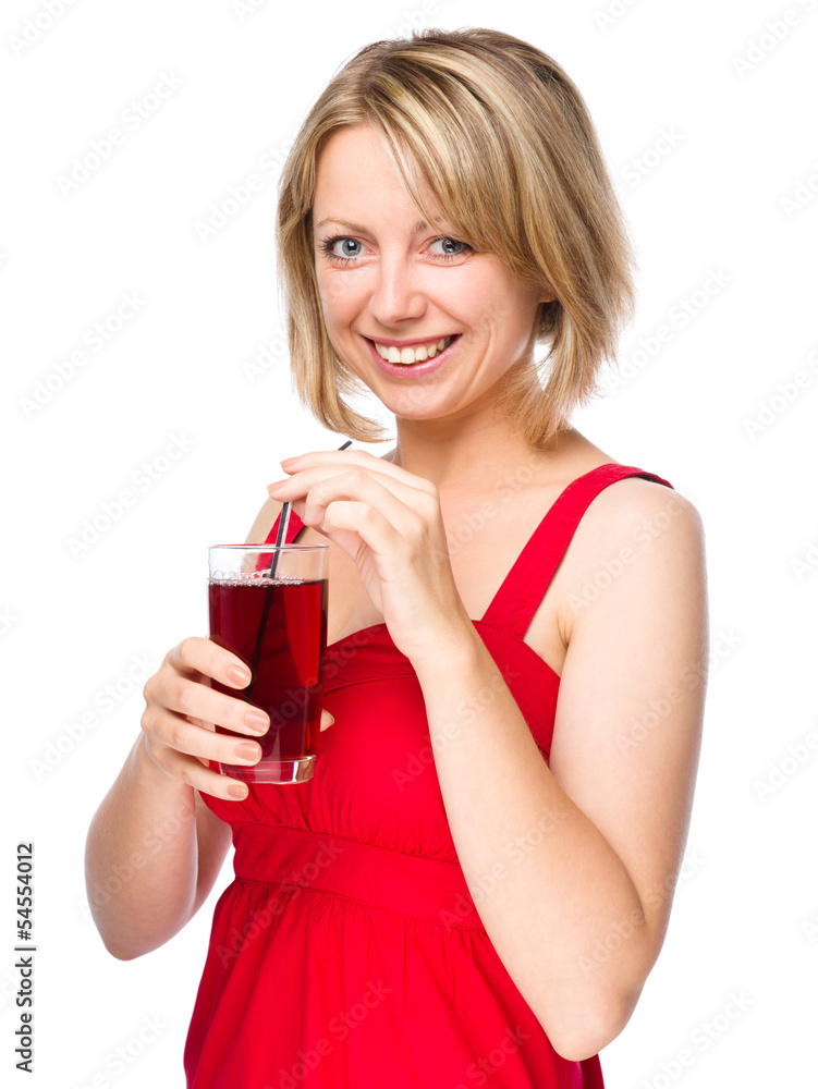 Young woman is drinking cherry juice Young woman is drinking cherry juice