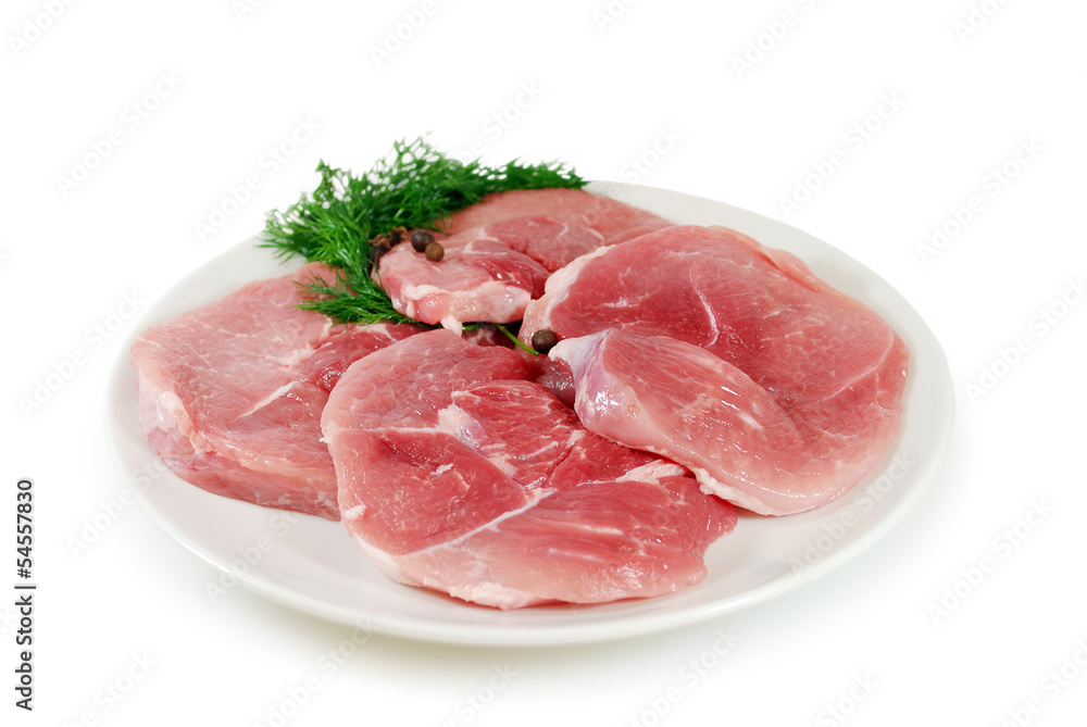Fresh raw pork on a plate isolated on white background
