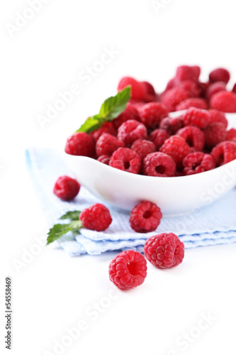Ripe sweet raspberries in bowls, isolated on white