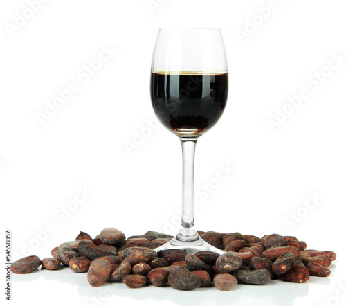 Glass of liquor and cocoa beans, isolated on white