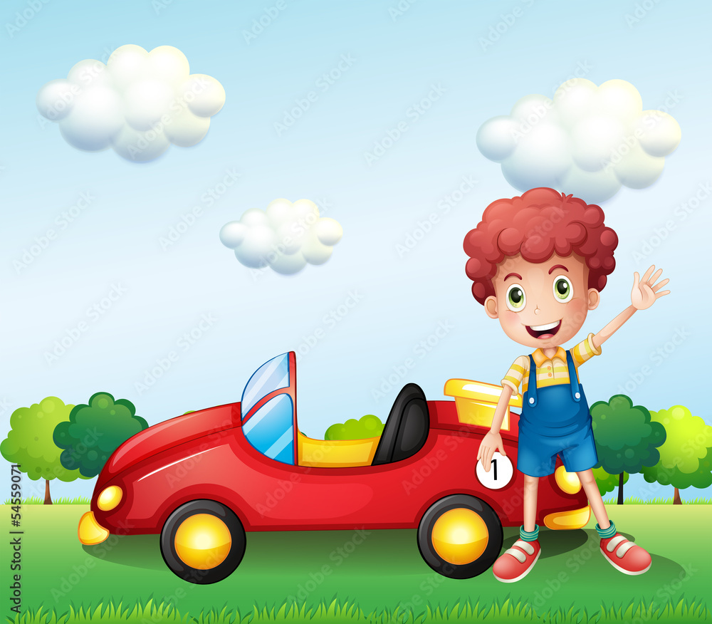 A boy waving his hand beside a car