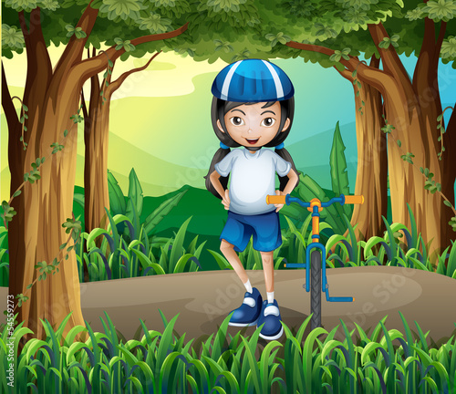 A girl standing beside her bike in the middle of the jungle