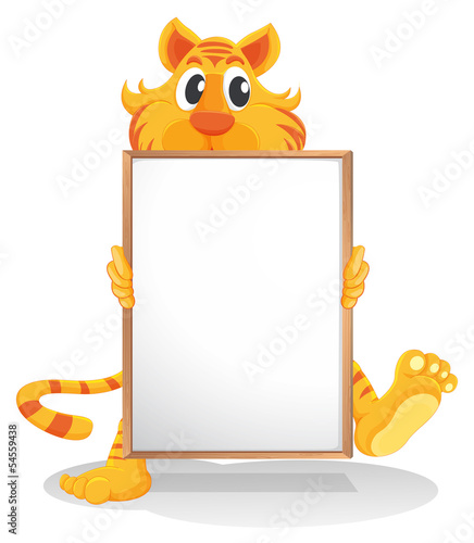 Fototapeta Naklejka Na Ścianę i Meble -  A tiger holding an empty whiteboard